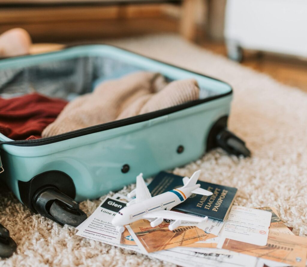 Our Amazon Travel Essentials Close-up of an open suitcase with travel essentials like passport and tickets, ready for a journey.